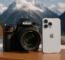 dslr and iPhone on a table with mountain backdrop